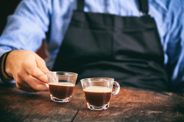 Barista and two espresso cups