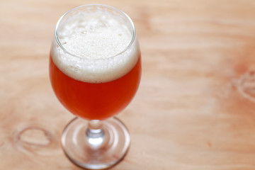 Glass of beer on wood