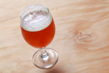 Glass of beer on wood