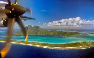 Bora Bora island and airplane propeller as seen when landing on small plane