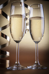 Two champagne glasses, on golden background