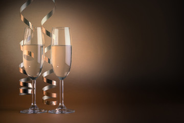Two champagne glasses, on golden background