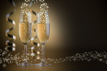 Two champagne glasses, on golden bokeh background