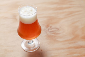 Glass of beer on wood