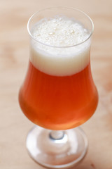 Glass of beer on wood