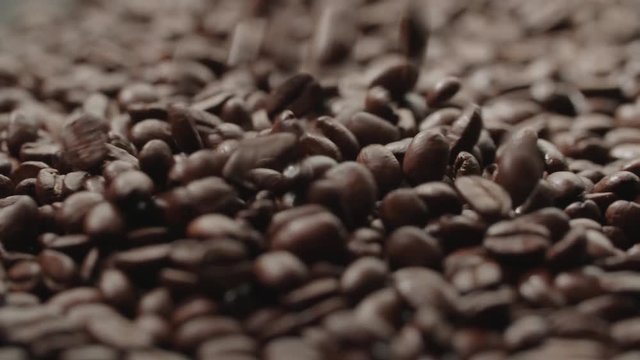quality of grain roasted coffee to spill in the bag , slow motion