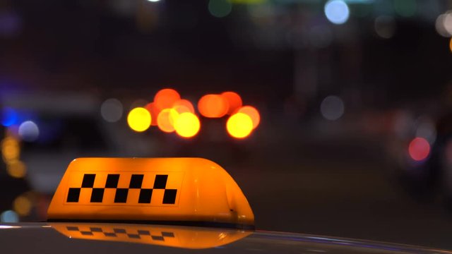 Taxi sign in traffic downtown