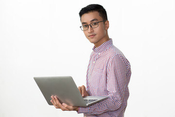 Smart young businessman holding portable computer