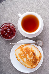 Top view of a plate of hot pancakes with vintage silver spoon an