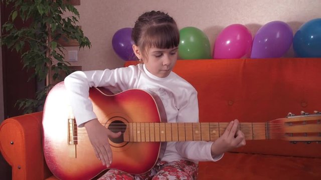 Child with guitar.
