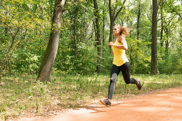 Jogging in park. Young female jogging in park