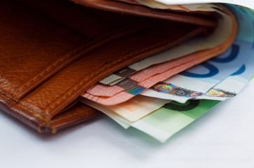 Brown leather wallet with money euro
