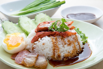 Barbecued red pork in sauce with rice, Chinese style roasted pork.