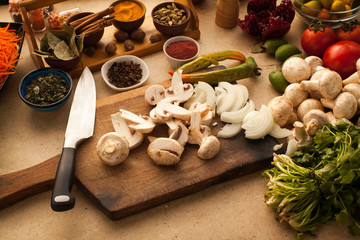 Sliced mushrooms on wooden board, prepared for cooking healthy vegetarian meal.