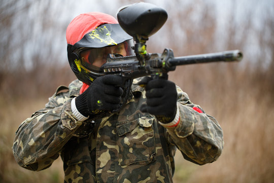 Paintball sport player wearing protective mask