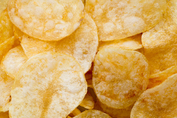 Close up potato chips on wood top view background.