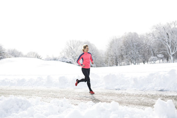Fototapeta na wymiar Fitness running woman in winter season