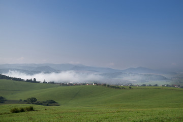 Misty morning with the view to the fog on meadow. Slovakia