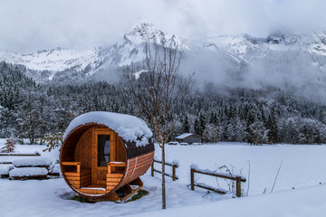 Wooden sauna in a snowy landscape 
