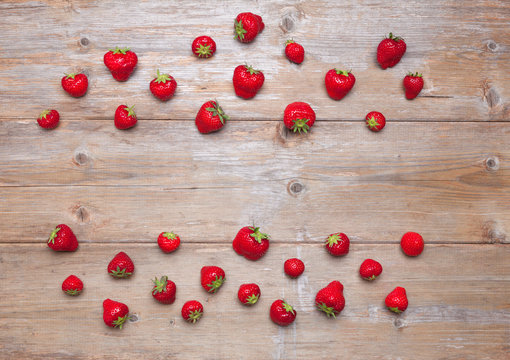 Top view of fresh strawberries on  a wooden surface