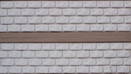 Wall made of decorative stone blocks painted in white