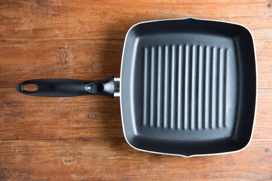 iron skillet on wooden table background.