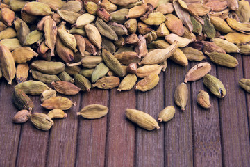 cardamom on a wooden striped background