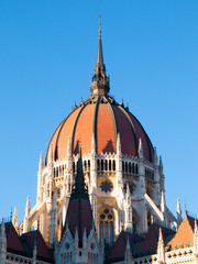 Detailed view of historical building of Hungarian Parliament, aka Orszaghaz, with typical central dome on clear blue sky background. Budapest, Hungary, Europe. It is notable landmark and seat of the