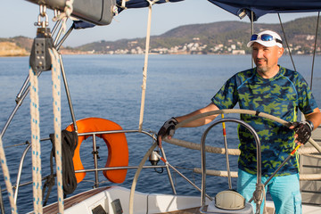 Man skipper during in the yachts boat race, sailing the Aegean sea.