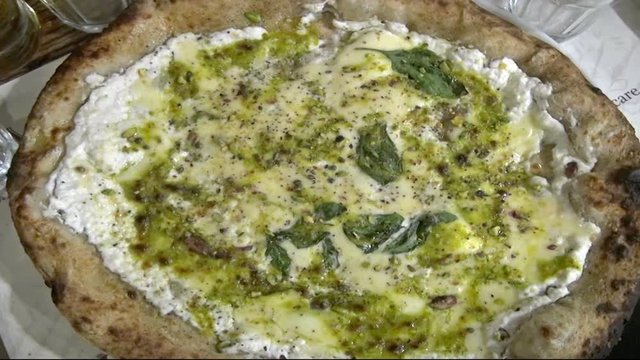 A pizza with pesto sauce in the pizzeria