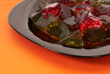 colored jelly on orange background
