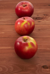 red apples on a wooden table