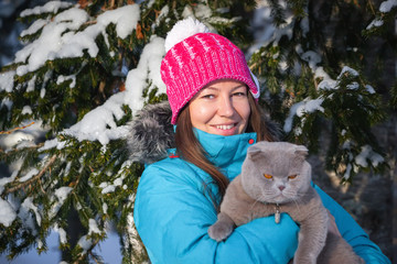 young woman with cat in winter
