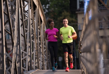 multiethnic couple jogging in the city