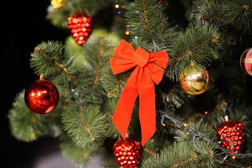 Christmas background with Christmas tree, Christmas ornaments and a big red bow