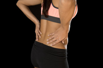 Fototapeta na wymiar hispanic fitness woman touching and grabbing her lower back suffering back pain