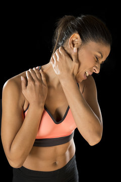 hispanic fitness woman touching and grabbing her neck and upper back suffering cervical pain