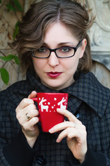 young woman drinking tea or coffee