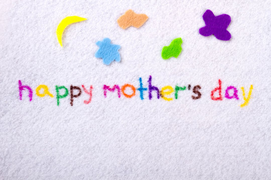 Happy Mother`s Day. Inscription on piece of cloth. Congratulations to dear moms. Handmade fabric product.