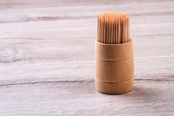 Box with toothpicks. Tothpicks on wooden surface. Clean teeth have better look. Simple rules of oral hygiene.