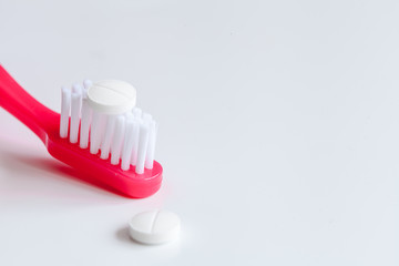 concept toothache with toothbrush and pills at white background