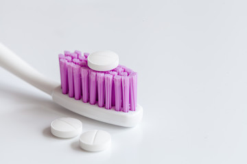 concept toothache with toothbrush and pills at white background