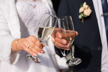 glasses with champagne in the hands of a beautiful wedding couple