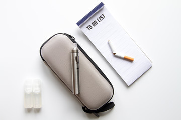 concept of electronic cigarette on white background top view