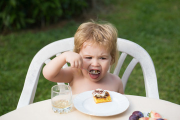 Baby boy eats dessert