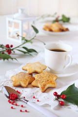  Christmas cookies, cup of coffee, holly and white lantern