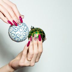 Female hands hold Christmas baubles