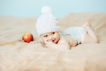 Little boy in white hat with apple