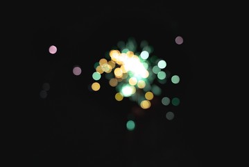 Light blur and defocus bokeh circles on black sky background