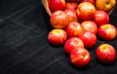 Basket of red apples on black